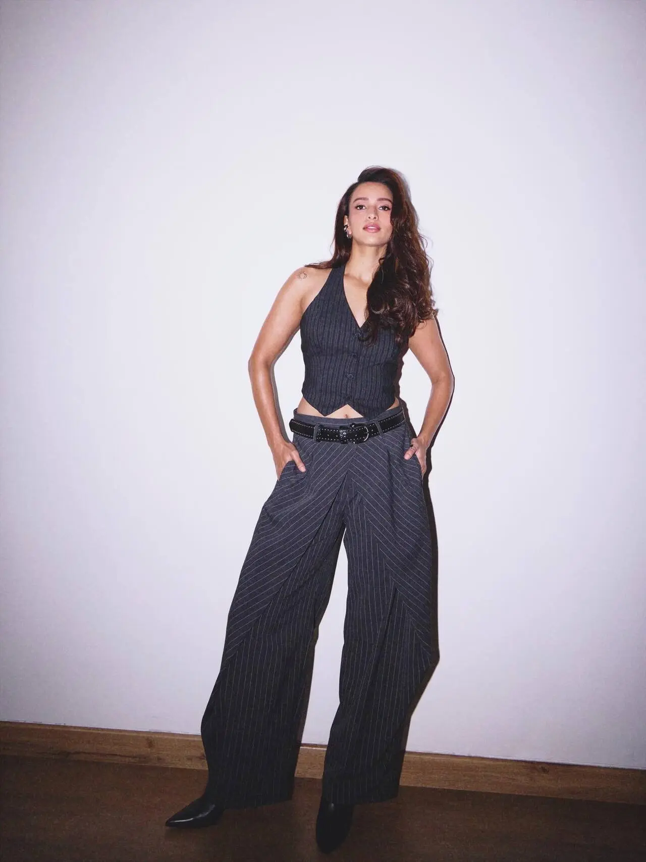 <p>Triptii Dimri turns up the heat in a chic black pinstripe halter top and wide-leg pants, exuding bold confidence and effortless glamour at Kala Ghoda Arts Festival.</p>